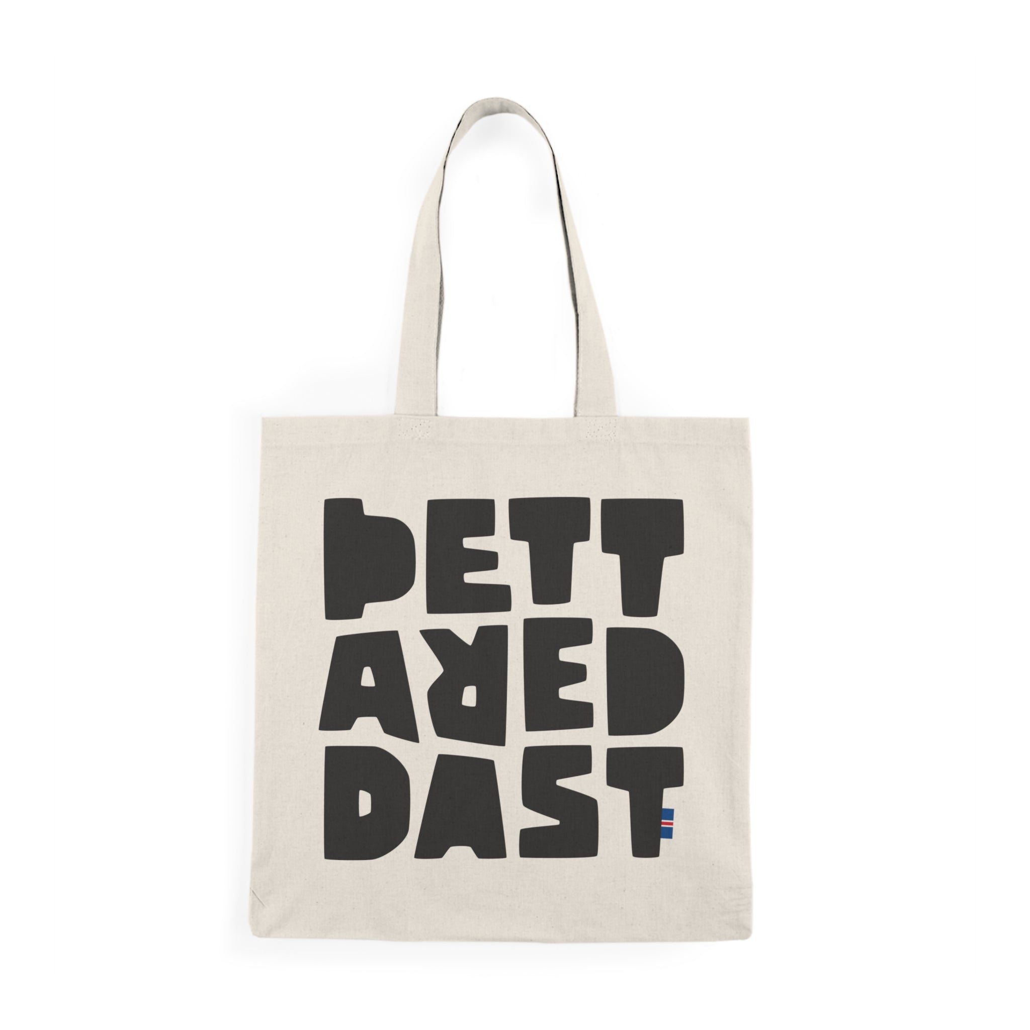 The Tote Bag Natural by Printify is a beige cotton tote featuring bold black "PETT AREDAST" text in a blocky font and a small striped accent at the bottom right—a sustainable choice ideal for daily use.