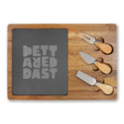 The Printify Charcuterie Board (Engraving) features a stylish acacia wood design with a dark slate center engraved "BETTERED PAST" and includes three wooden-handled cheese knives in side slots—perfect for any charcuterie spread.