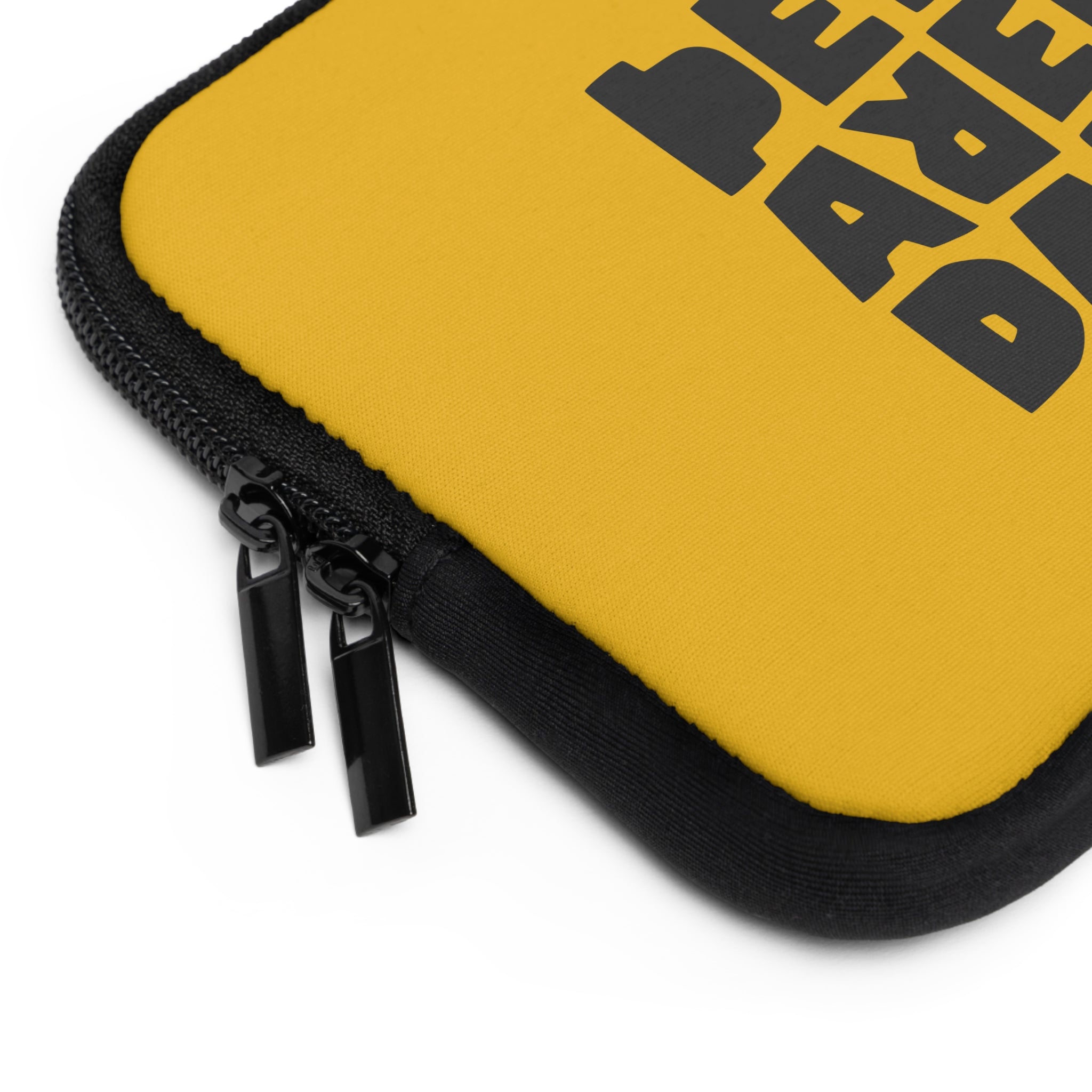 Close-up of Printify's "Copy of Laptop Sleeve," a yellow water-resistant case with black fabric edges and large black text partially visible on the surface.