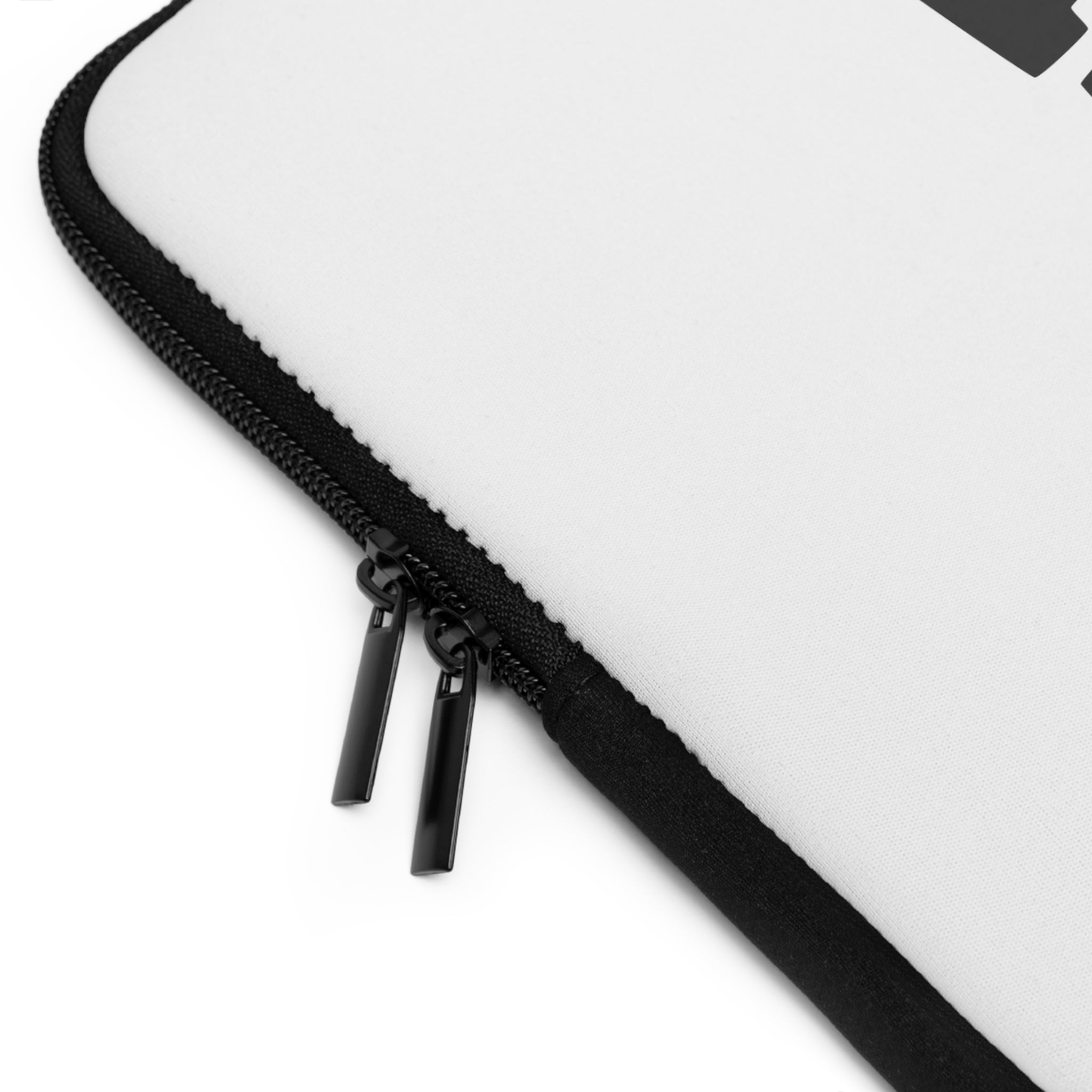 Close-up of a black double zipper on a white Printify Laptop Sleeve with black edge trim.