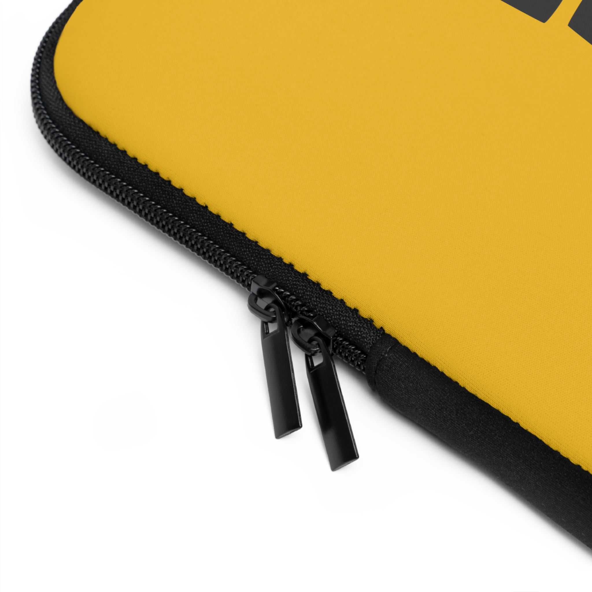 Close-up of the Copy of Laptop Sleeve by Printify, a yellow water-resistant laptop case featuring a black zipper with two pulls.