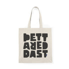 The Tote Bag Natural by Printify is a natural-colored cotton tote featuring large, bold black letters spelling "PETT ARED DAST" on the front—a stylish and eco-friendly choice for daily use.