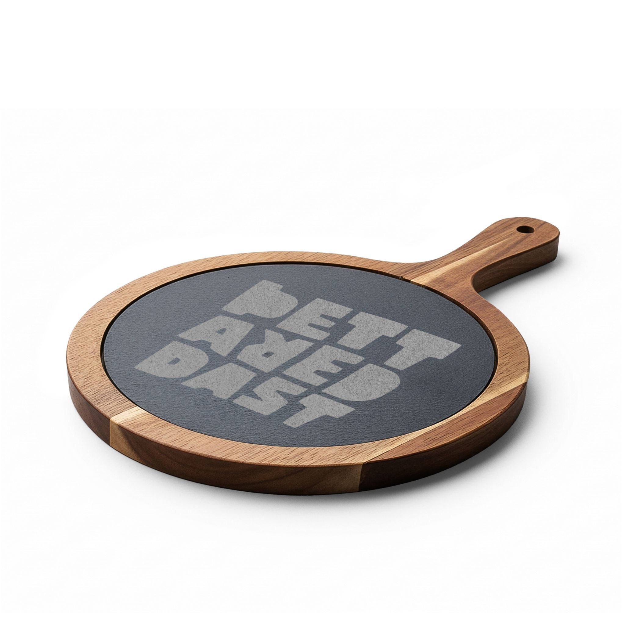 The Printify Charcuterie Board (Engraving) is a round acacia wood board with a handle and a dark slate center engraved with "BETTAVED DIST" in bold letters—an ideal personalized serving piece for any occasion.