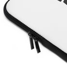 Close-up of a Printify Laptop Sleeve in white, featuring water-resistant material, black trim along the edge, and two black zipper pulls.