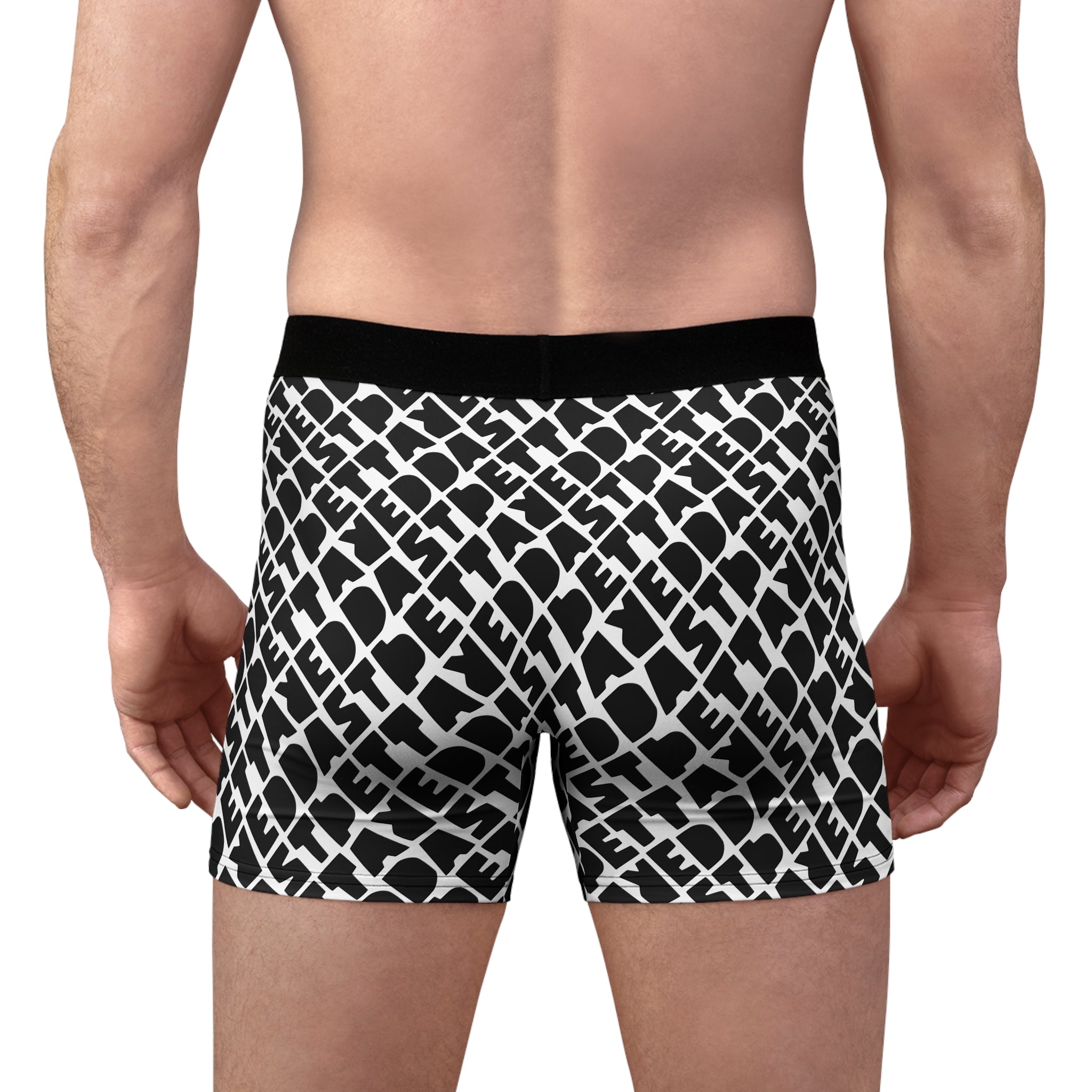 A person faces away from the camera, wearing Printify Men's Boxer Briefs (AOP) with a black and white pattern and a lightweight black waistband.
